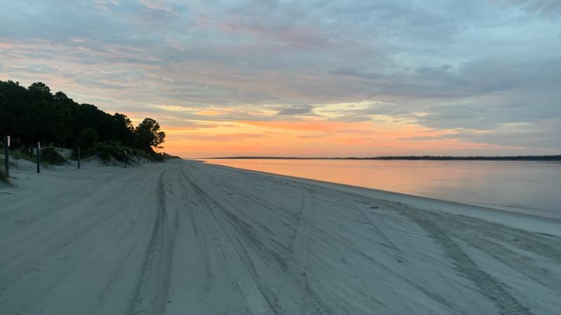 The sun rises over the beach at Amelia Island State Park.