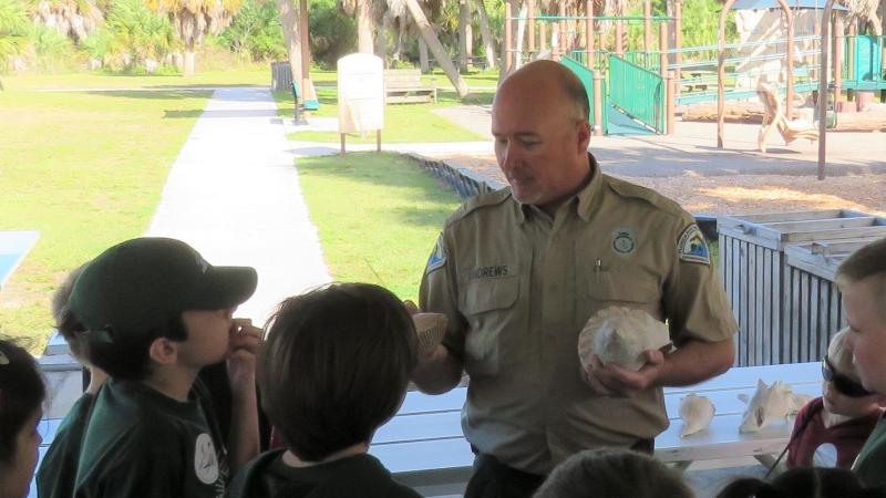 Todd speaking to a group of children.