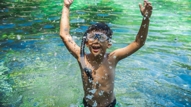 Child enjoying swimming at the spring